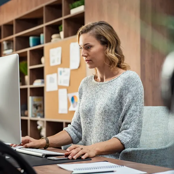 Donna bionda lavora al computer su una standing desk